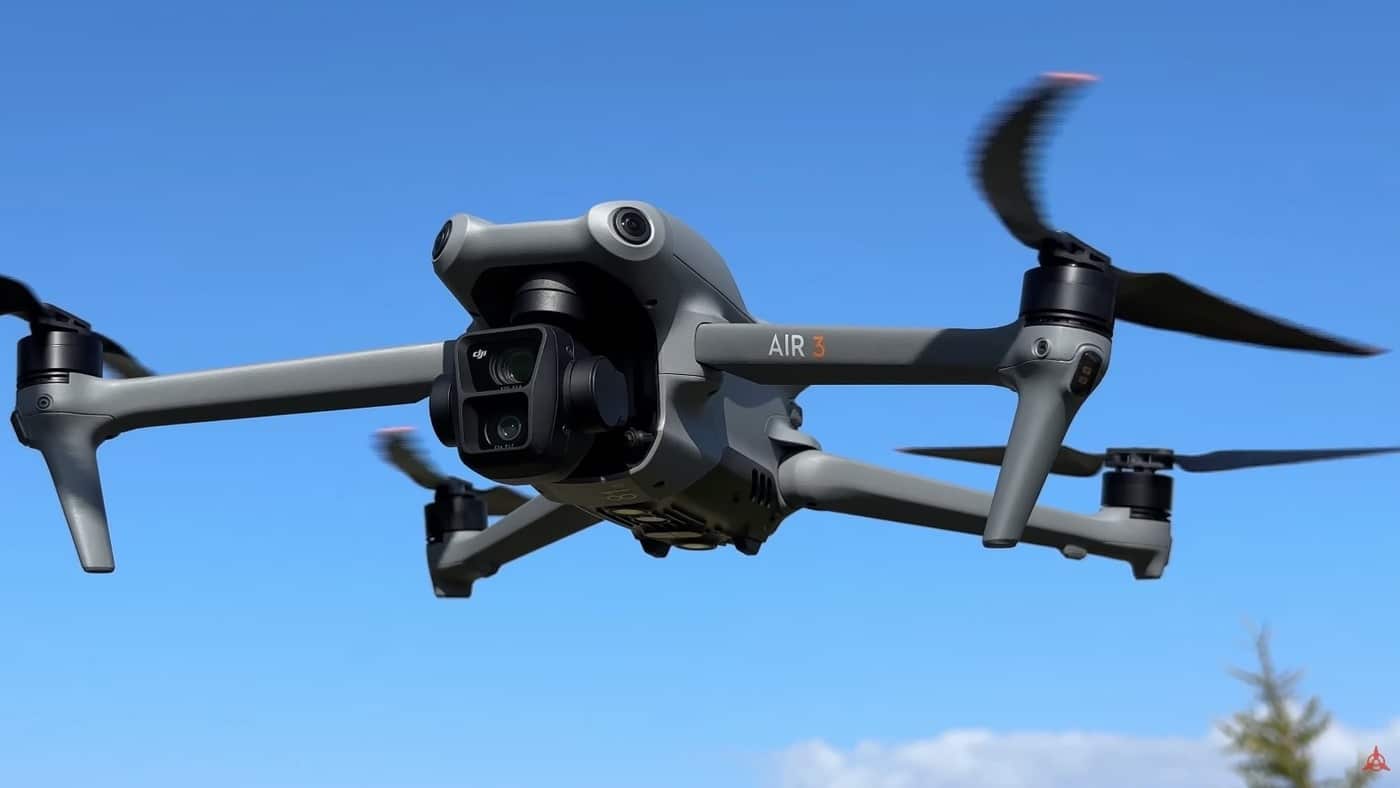 The DJI Air 3 hovering above a treeline during the mid-tier drone section.
