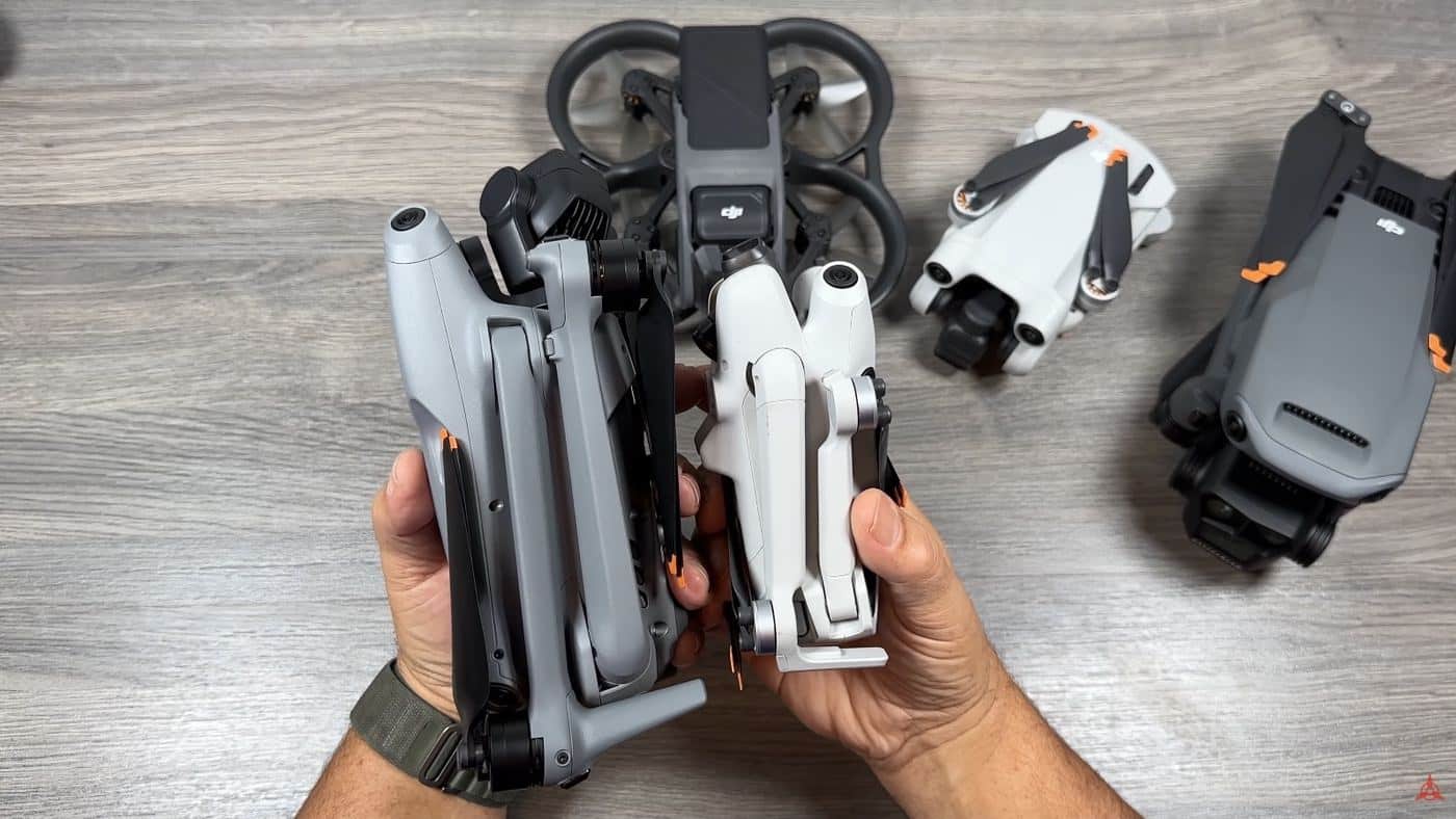 The DJI Mini 4 Pro and the larger DJI Air 3 placed side by side.