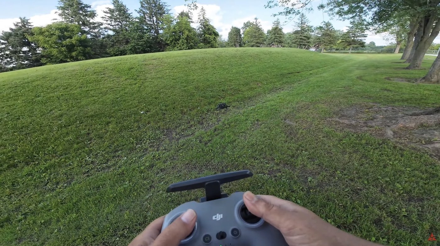 The DJI Avata flying a low proximity line through a forest canopy.