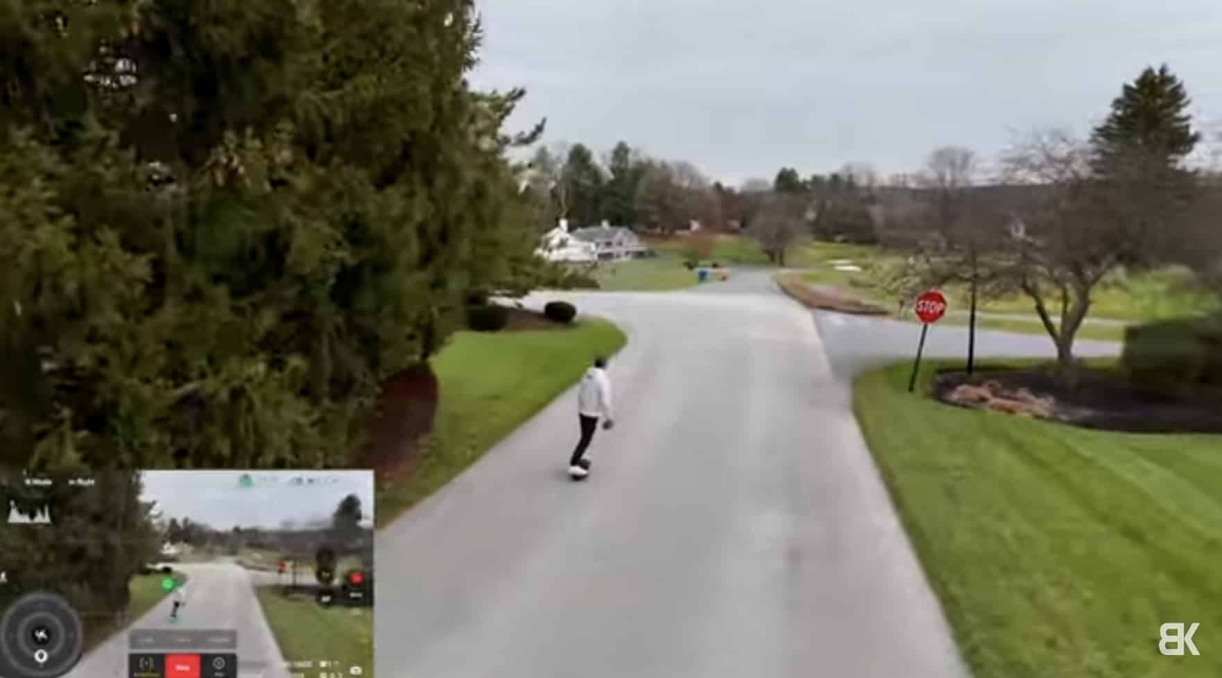 ActiveTrack footage of a skateboarder on a tree-lined road with an inset feed.
