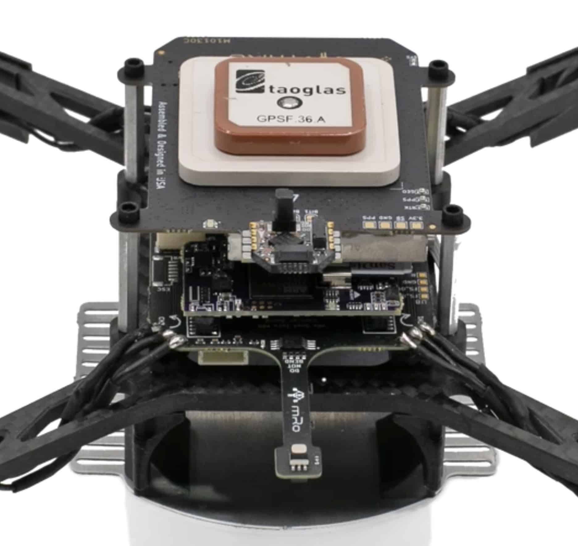 Exposed carbon airframe of a 3DR quadcopter topped with a Taoglas GPS antenna.