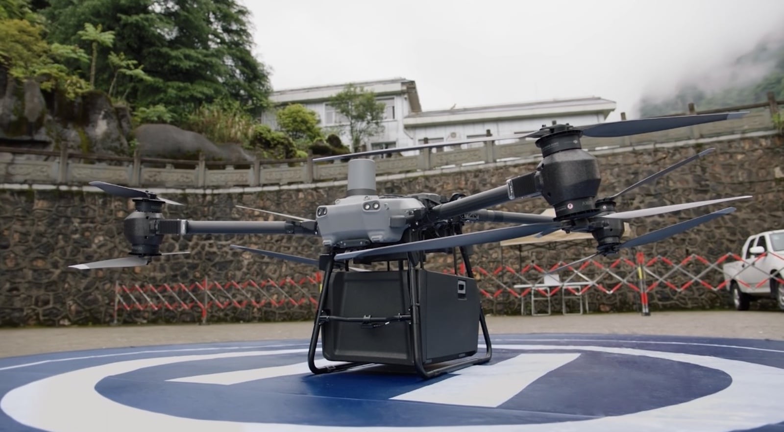 The FlyCart 30 on a landing pad with its 70-liter cargo case attached.