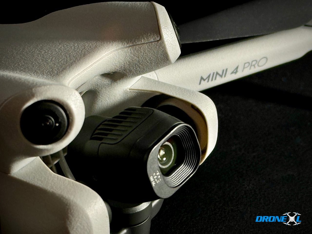 Close-up of a DJI Mini 4 Pro gimbal camera and forward vision sensor.