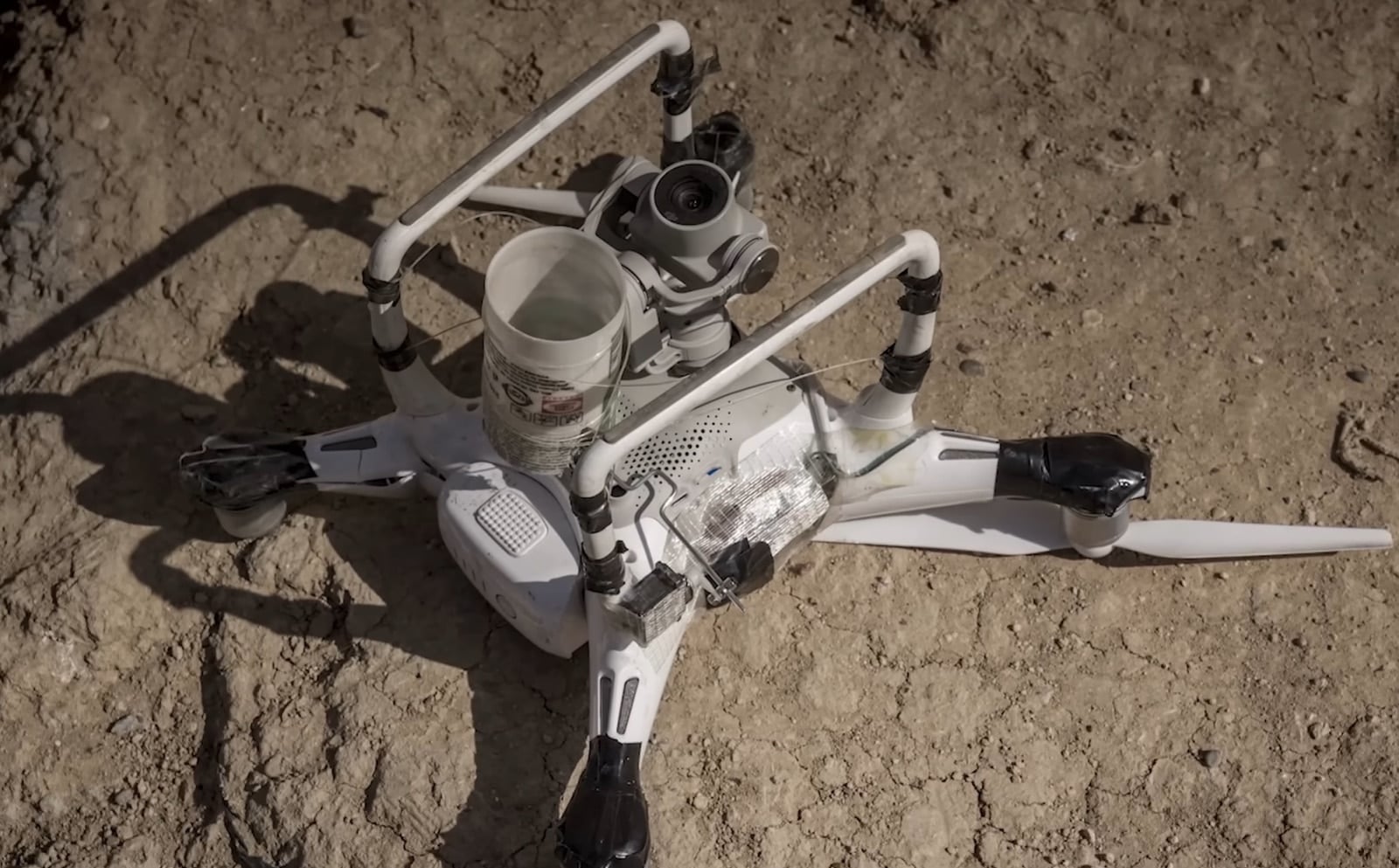 Small civilian drone rigged to carry an improvised explosive payload.