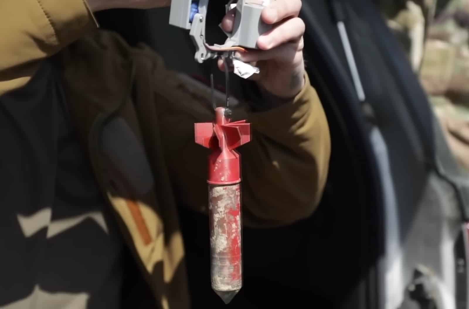 Soldier aiming an M4 fitted with the Smart Shooter optic at an aerial target.