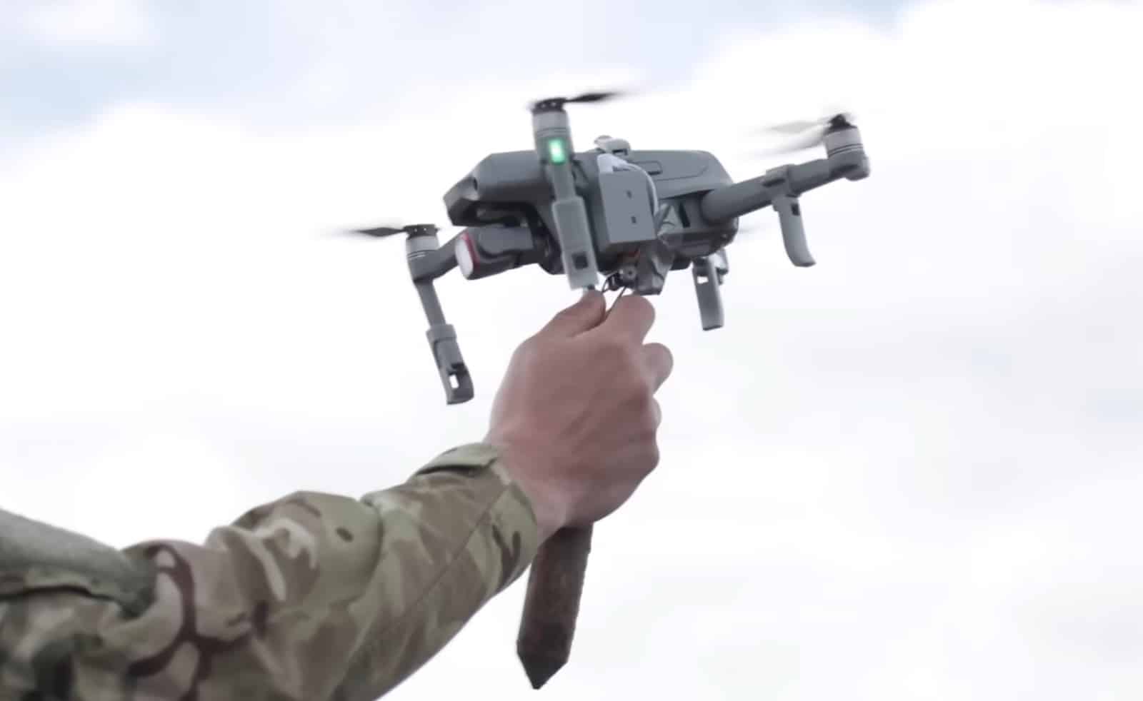 Trainee raising a Dronebuster jammer to interdict an incoming small drone.