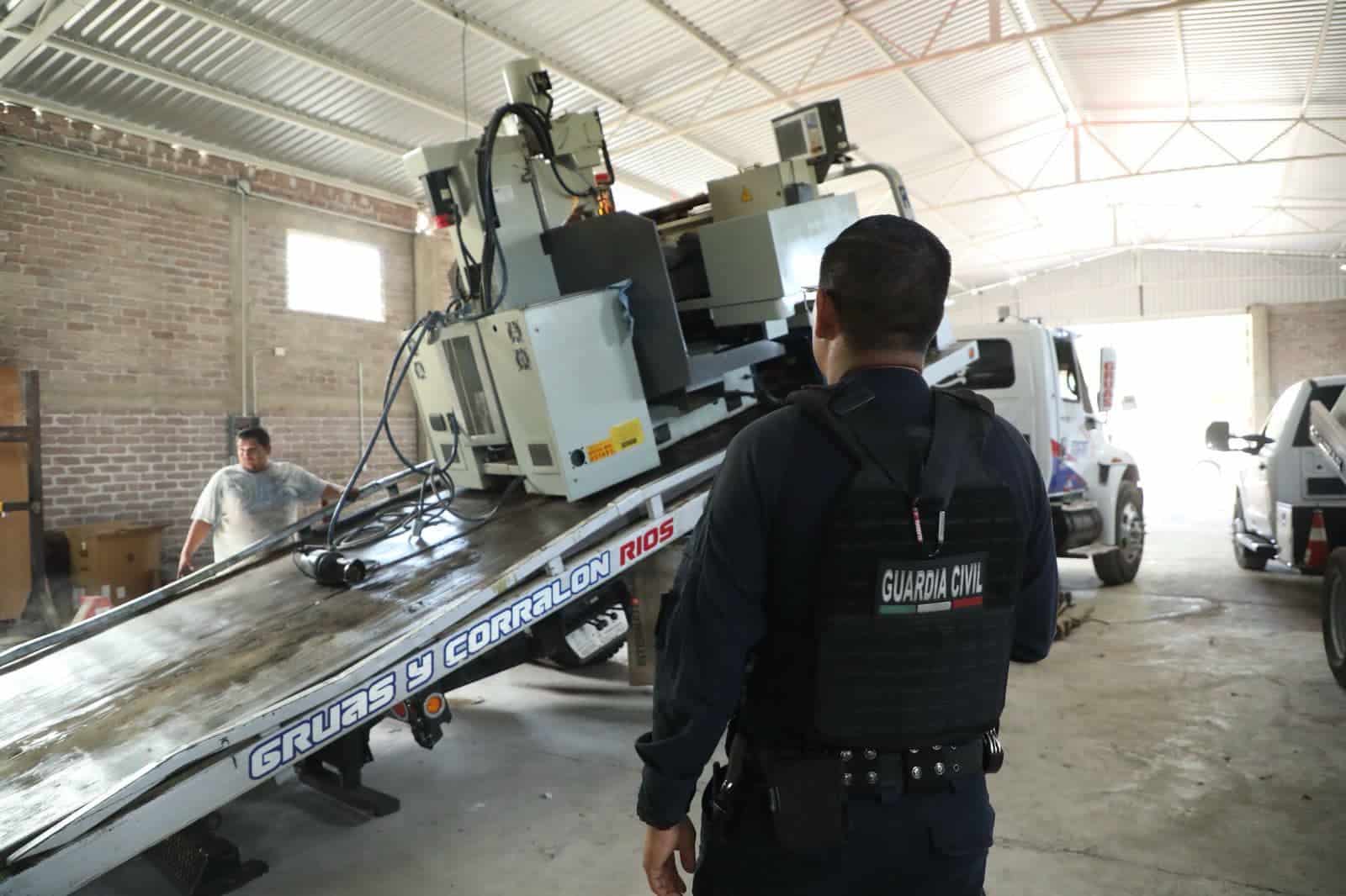 Weapons and counterfeit Mexican military uniforms seized at the Michoacan workshop.