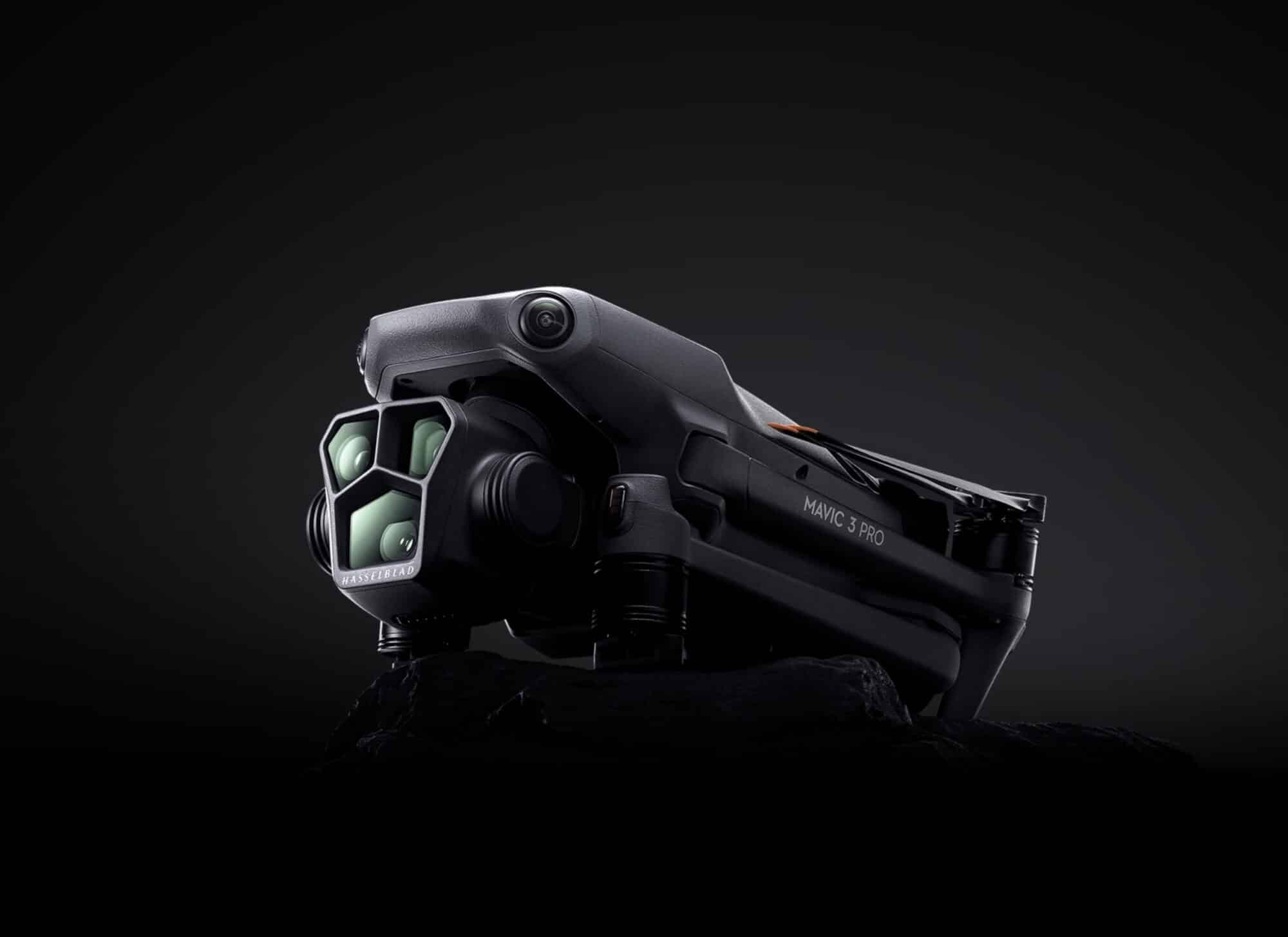 DJI Mavic 3 Pro posed on black with its triple-camera gimbal forward.