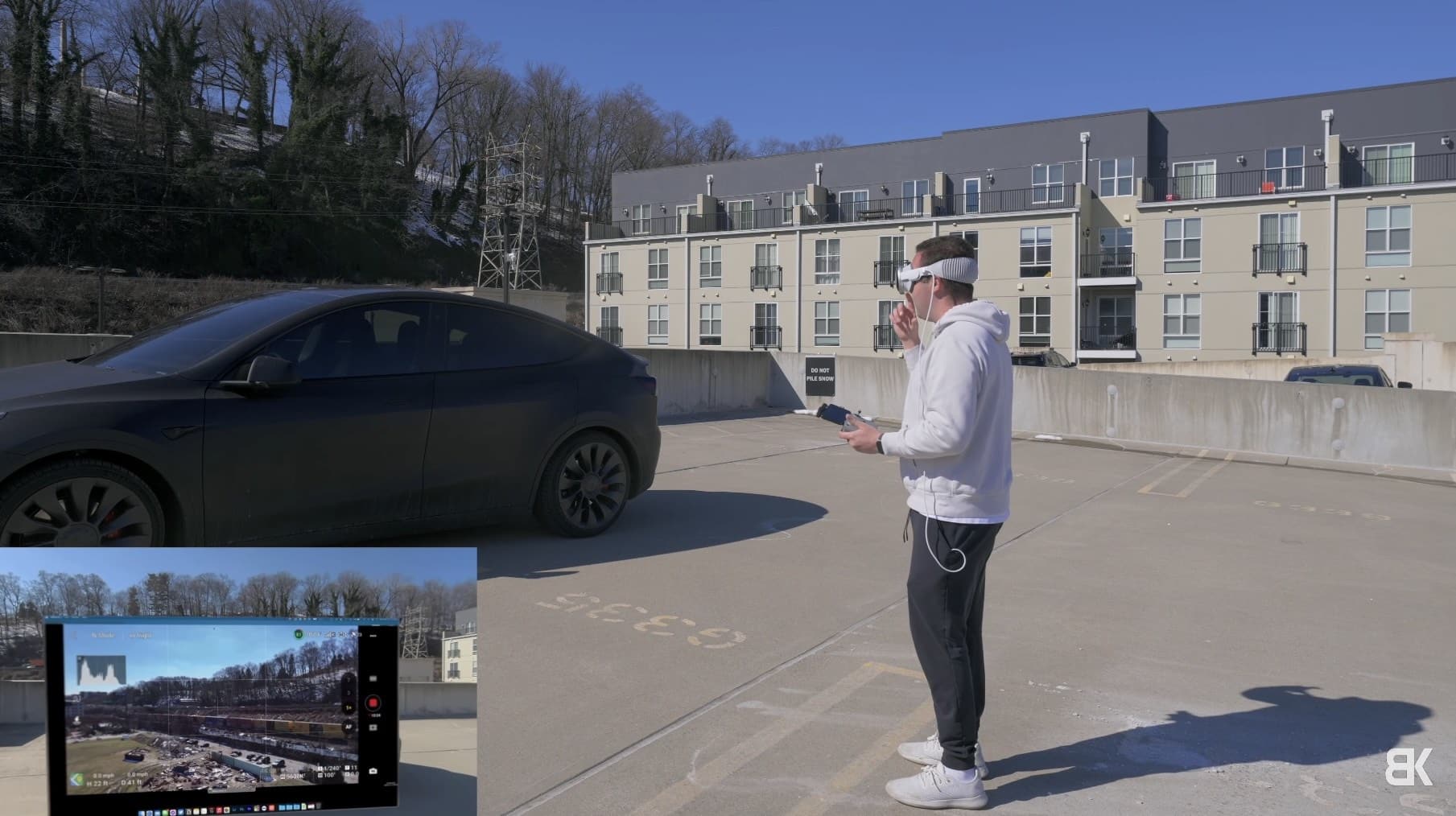 Billy standing outside in bright sun with the Vision Pro and his controller.