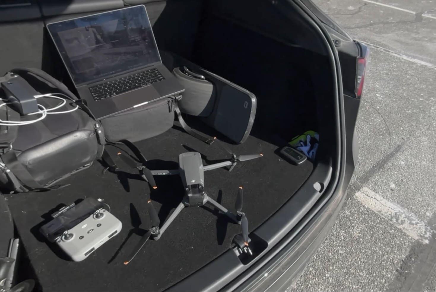 Billy Kyle's car trunk setup with MacBook and battery bank used while flying.