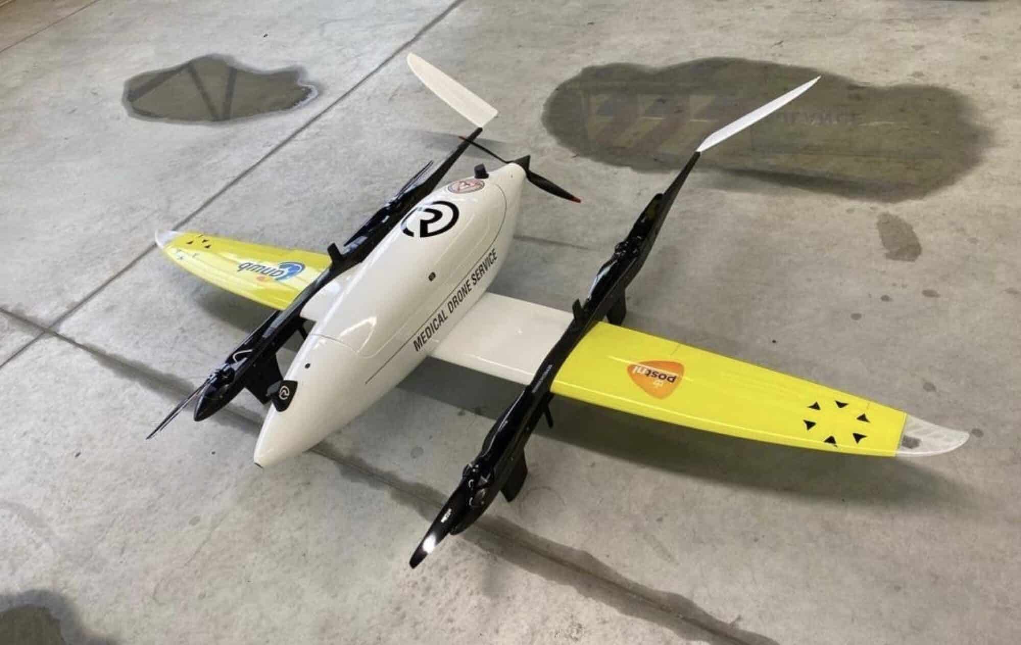 RigiTech Eiger fixed-wing VTOL delivery drone parked on a concrete apron.