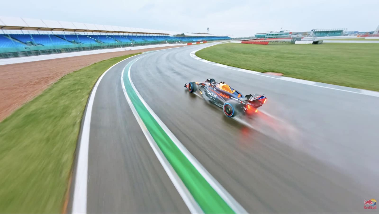 Chase-camera view of a Formula 1 car accelerating along the Silverstone circuit.