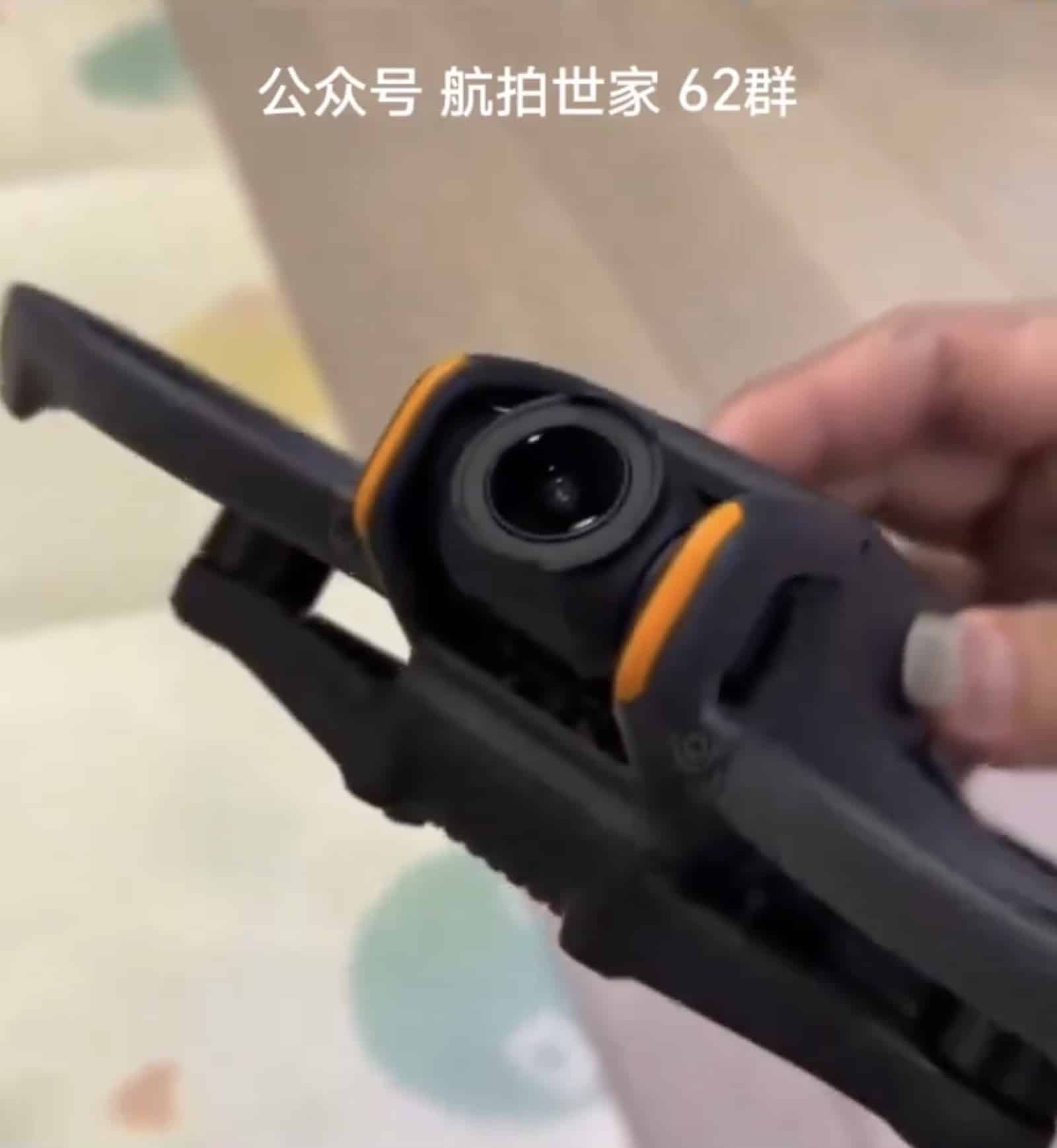 Front of the DJI Avata 2, its camera flanked by orange protective bumpers.