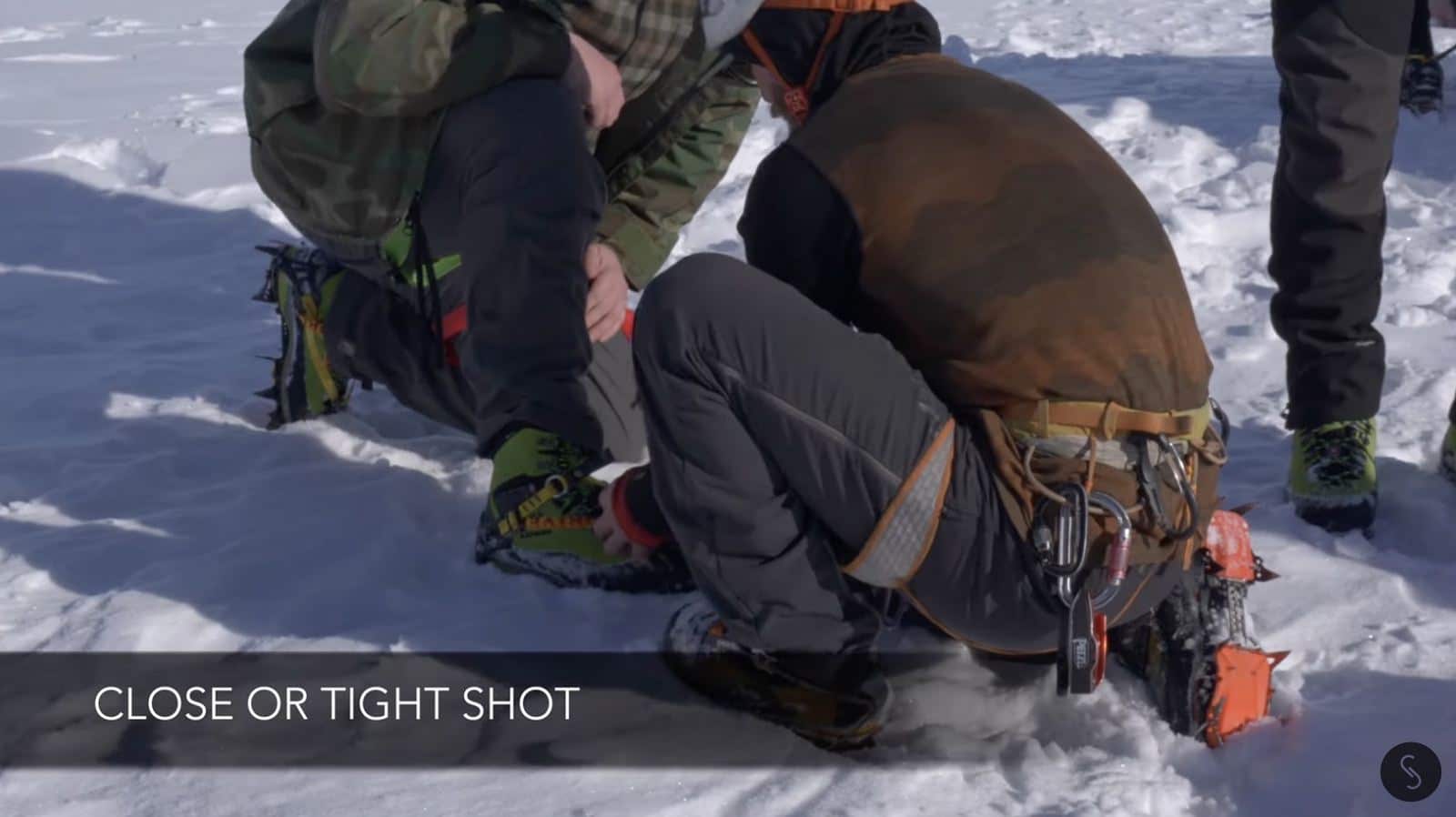 Ground-camera shot of the ice climbers preparing for their ascent.