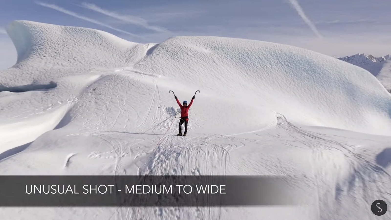 Top-down drone view of a climber on the iceberg, the unusual shot in the sequence.