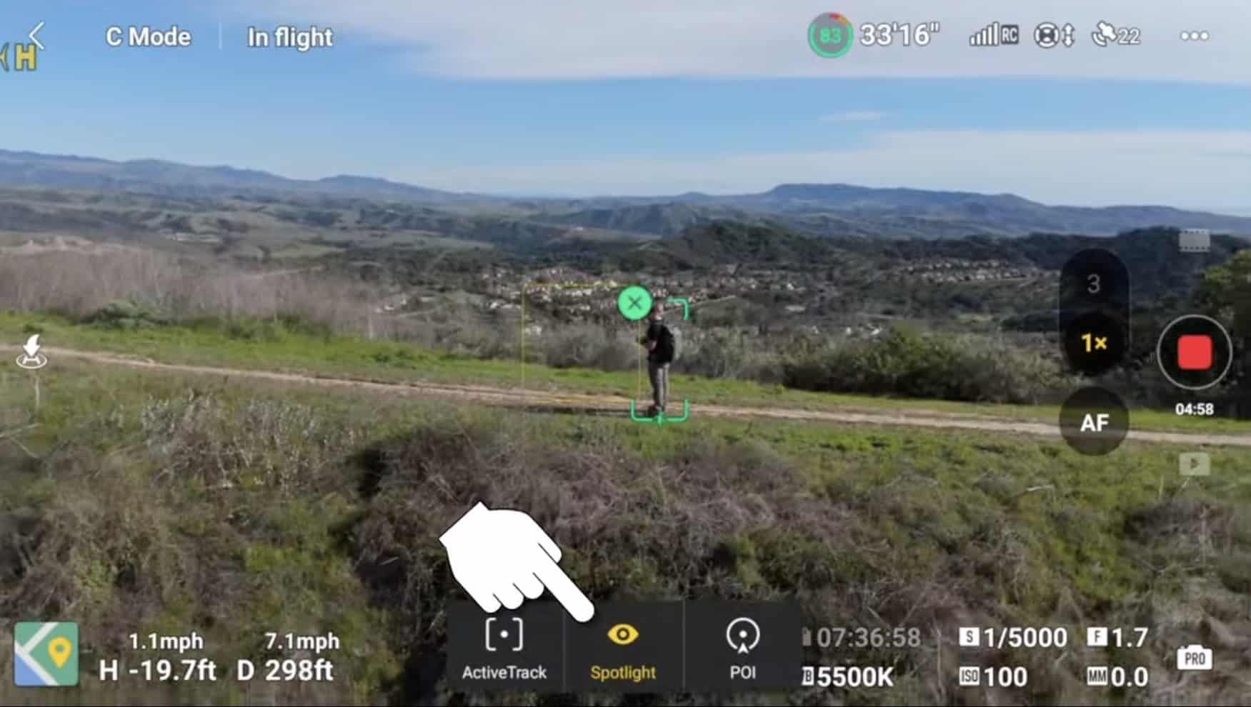 DJI Fly flight screen with ActiveTrack and Spotlight controls tracking a hiker below.