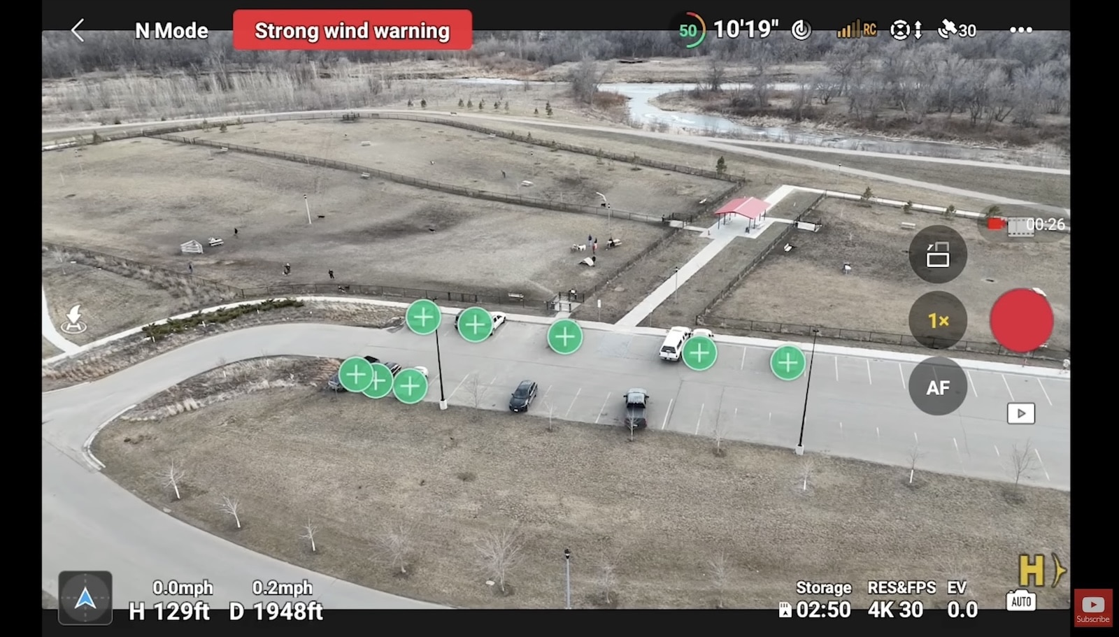 Screenshot of the DJI Fly app showing subject scanning markers and a strong wind warning.