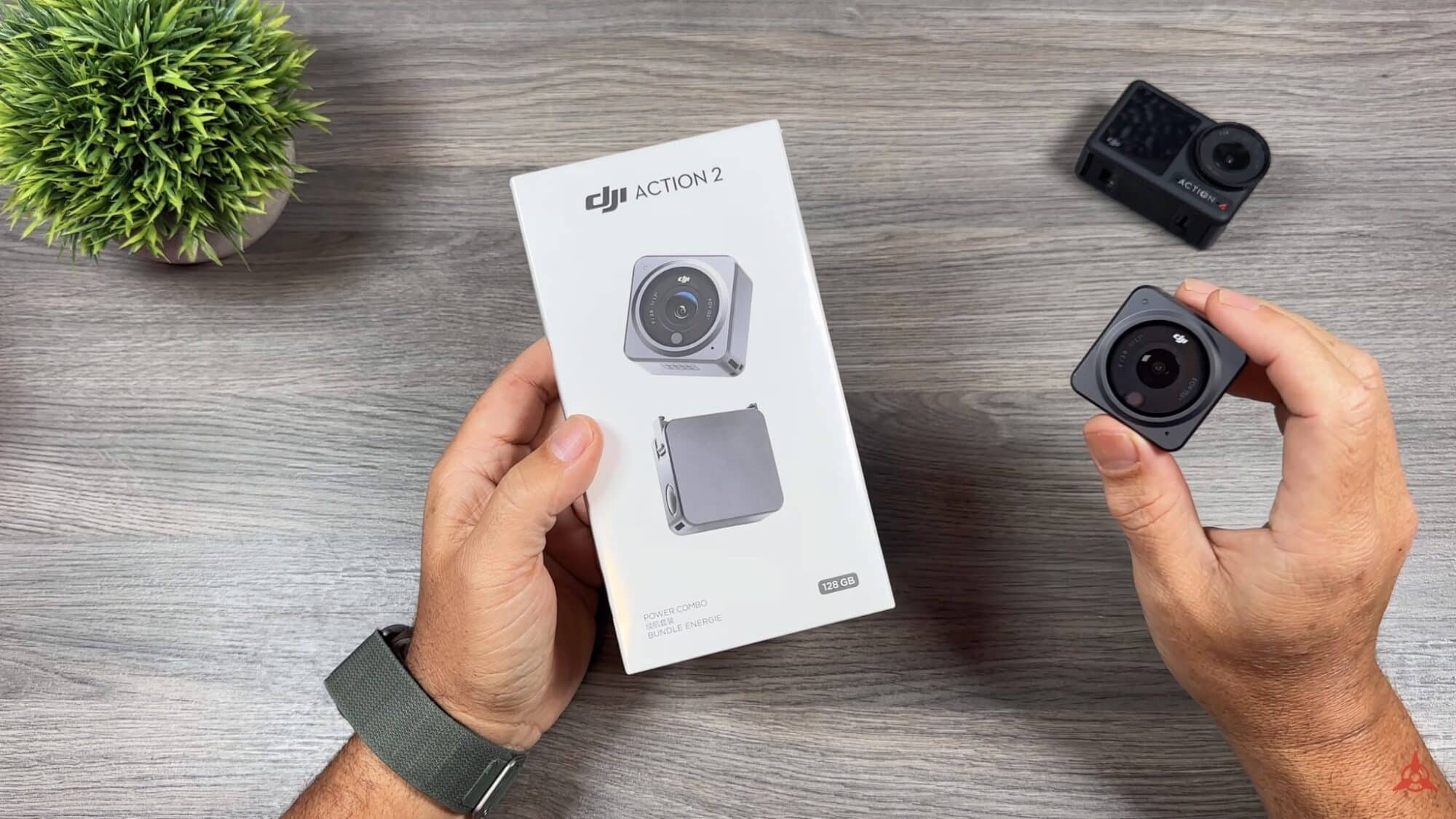 Hands unbox a DJI Action 2 with its retail box and two camera modules.