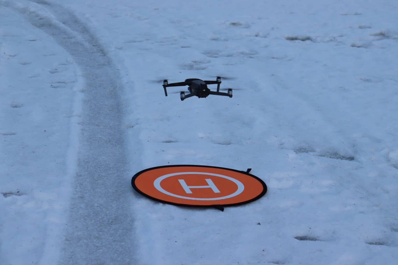 DJI Mavic 2 hovering over a landing pad during Alaska DEC flight training.