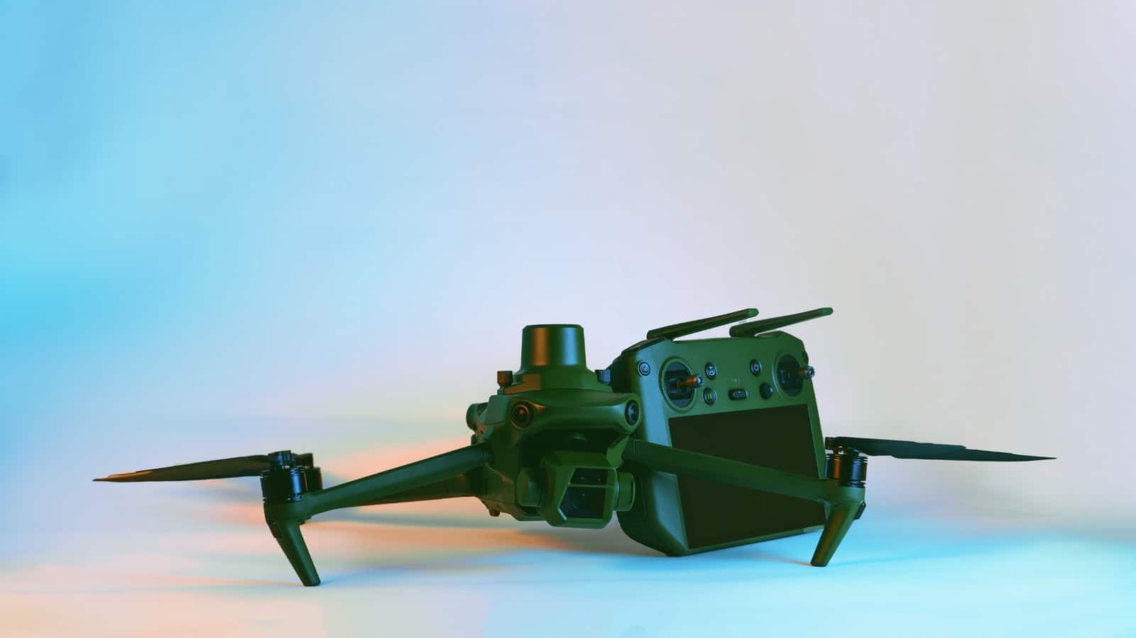 Anzu Raptor drone and its controller posed against a pastel studio gradient.