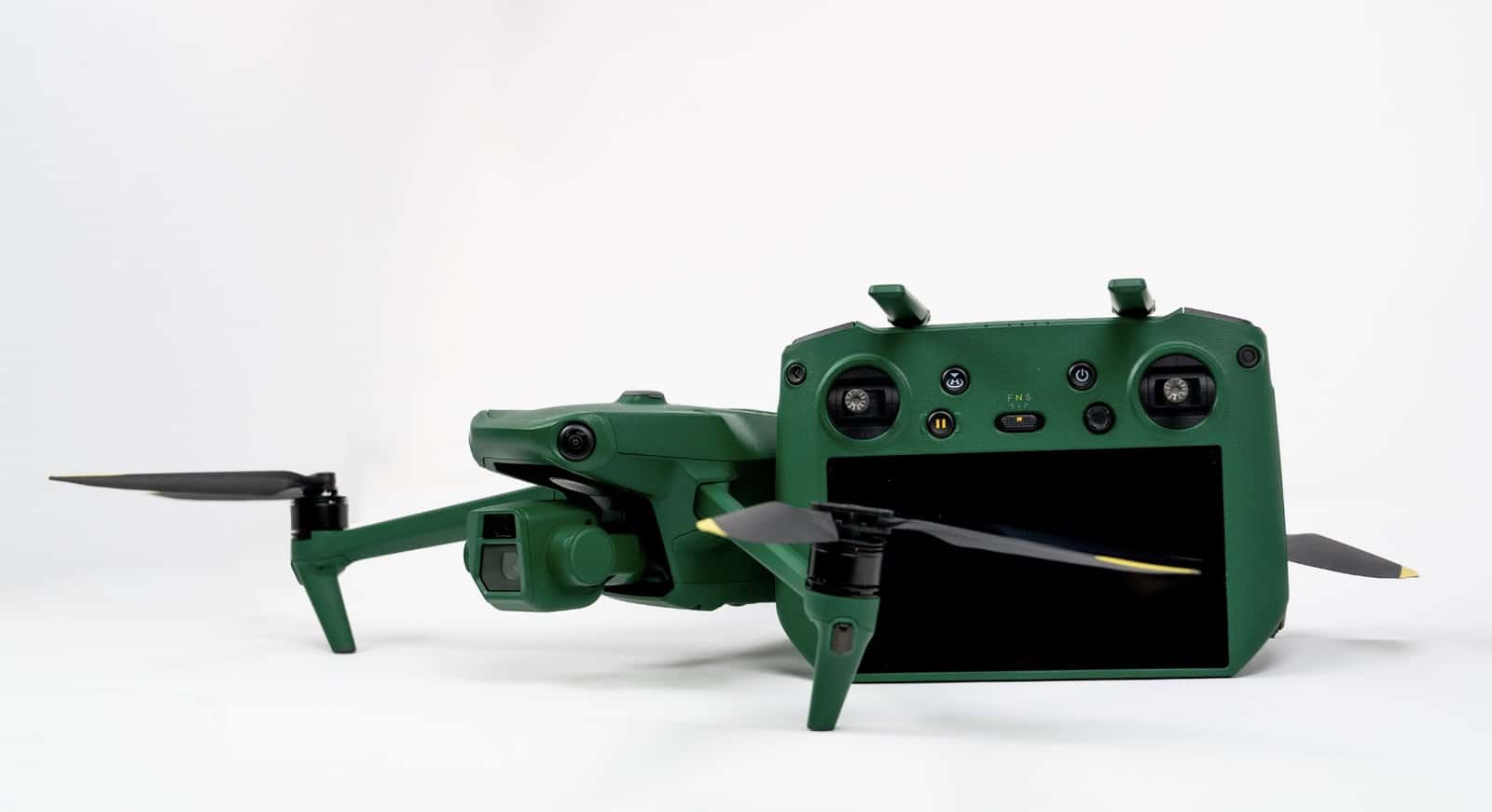 Green Anzu Robotics Raptor drone folded beside its matching green smart controller.