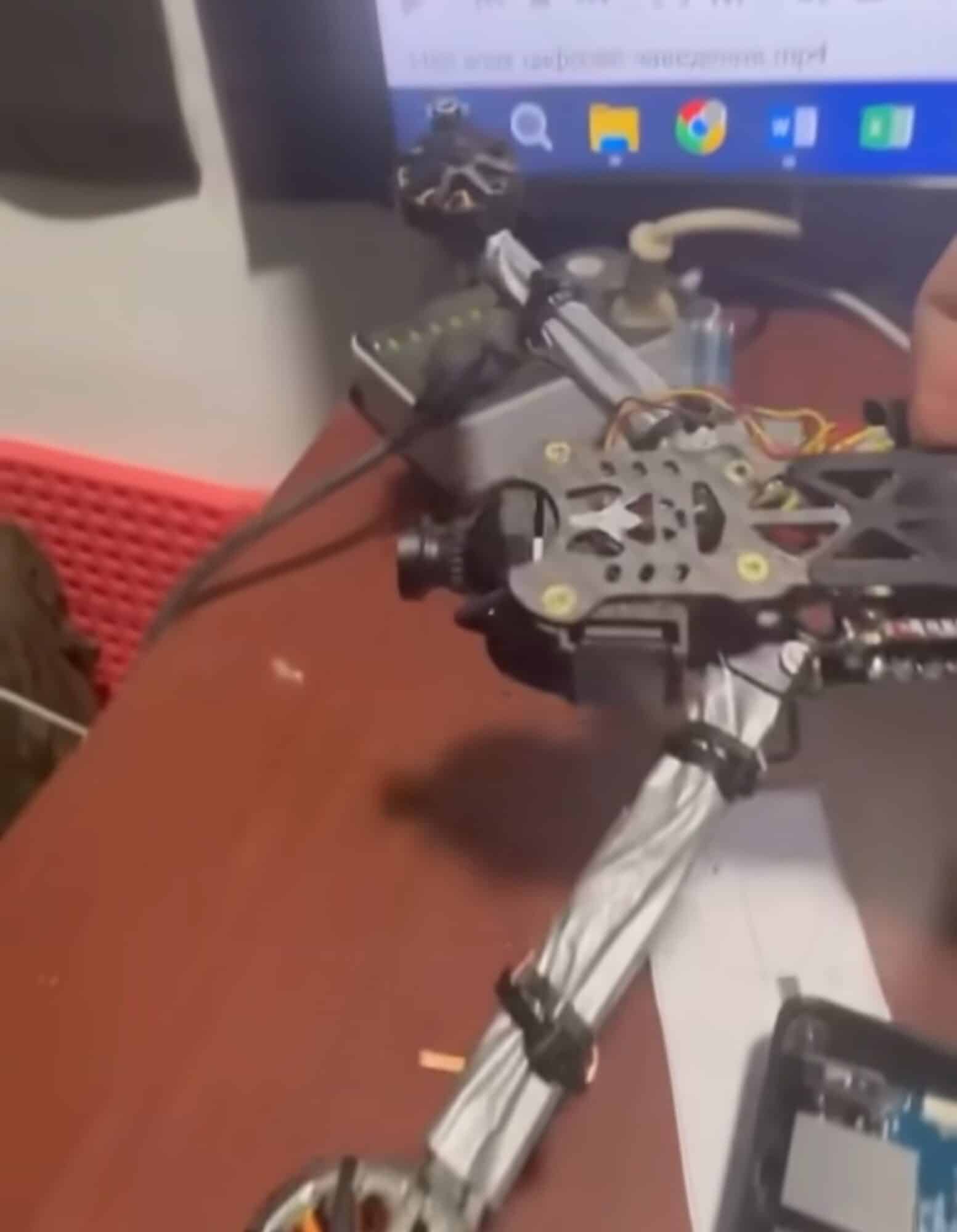 Ukrainian forces examining components of the downed Russian machine vision drone.