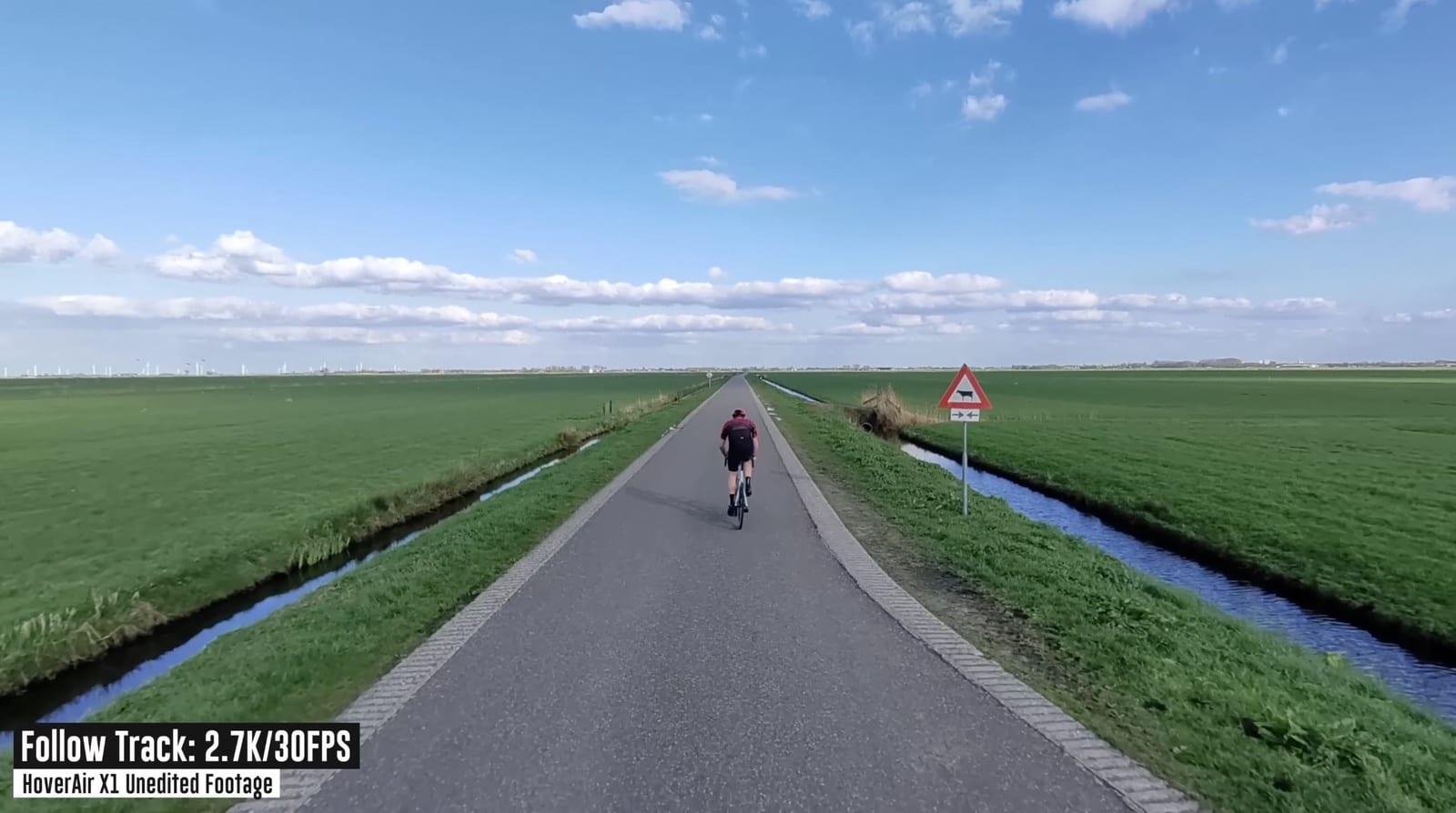 HoverAir X1 tracking a road cyclist before dropping off at higher speed.