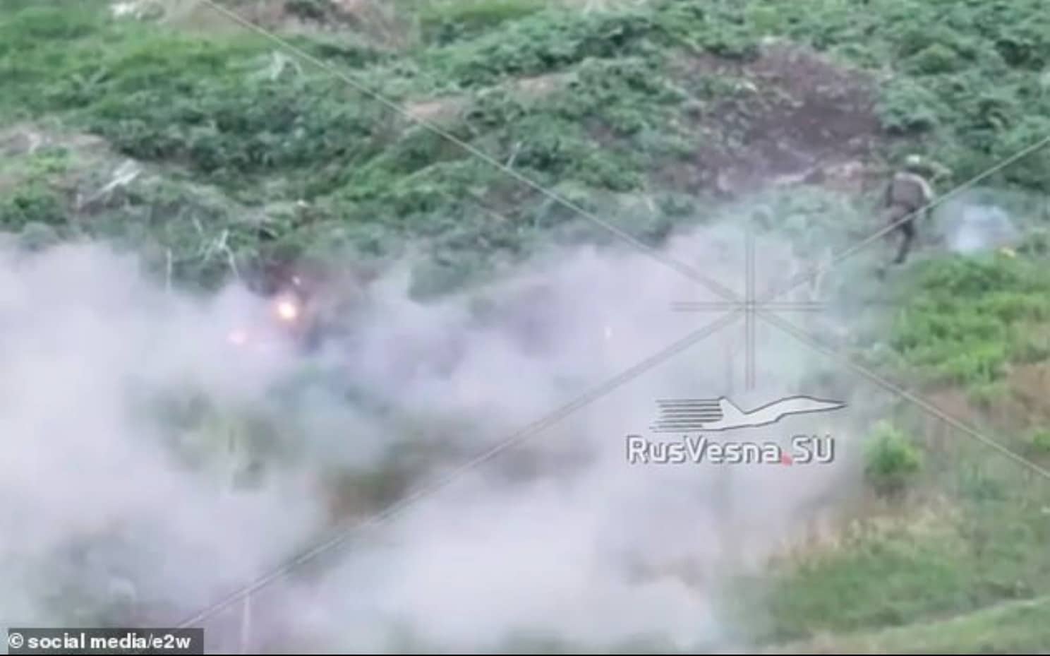 Private Khamatov running for the tree line through thick white smoke.