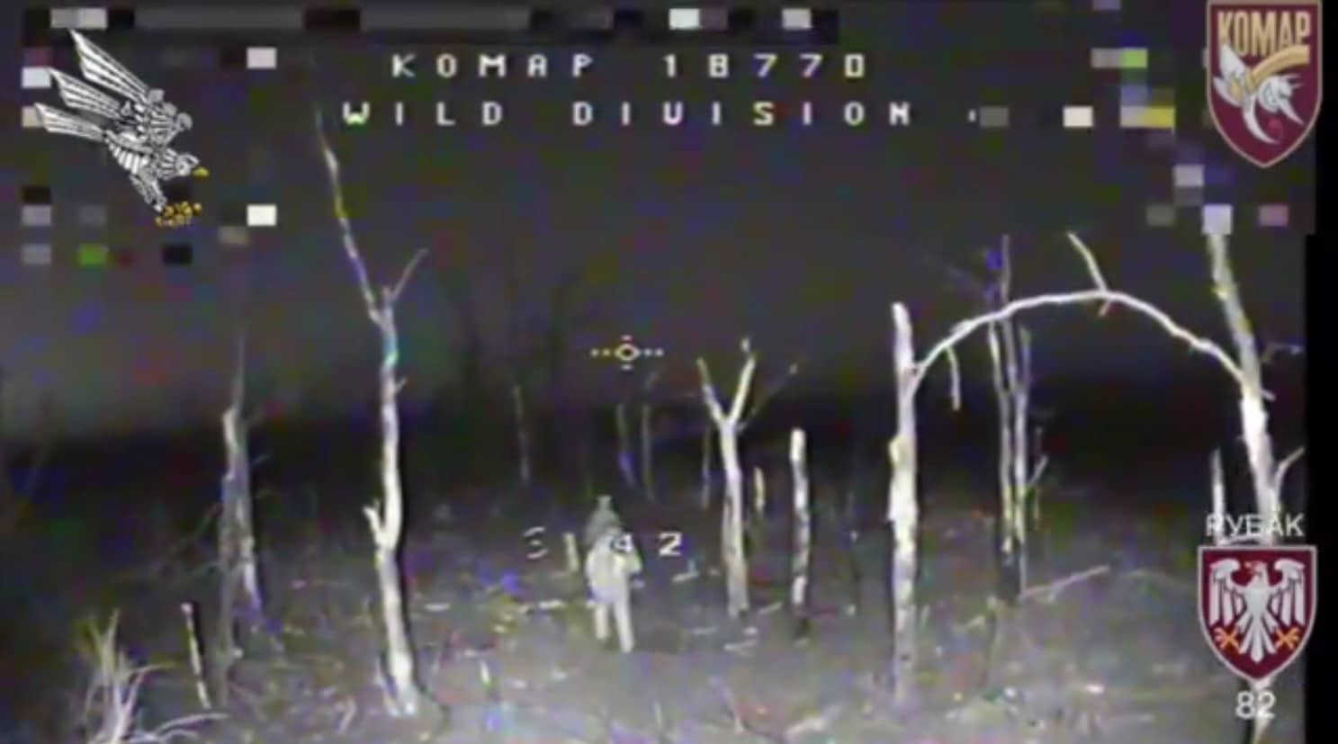 Night vision drone footage showing two Russian soldiers in a wooded area.