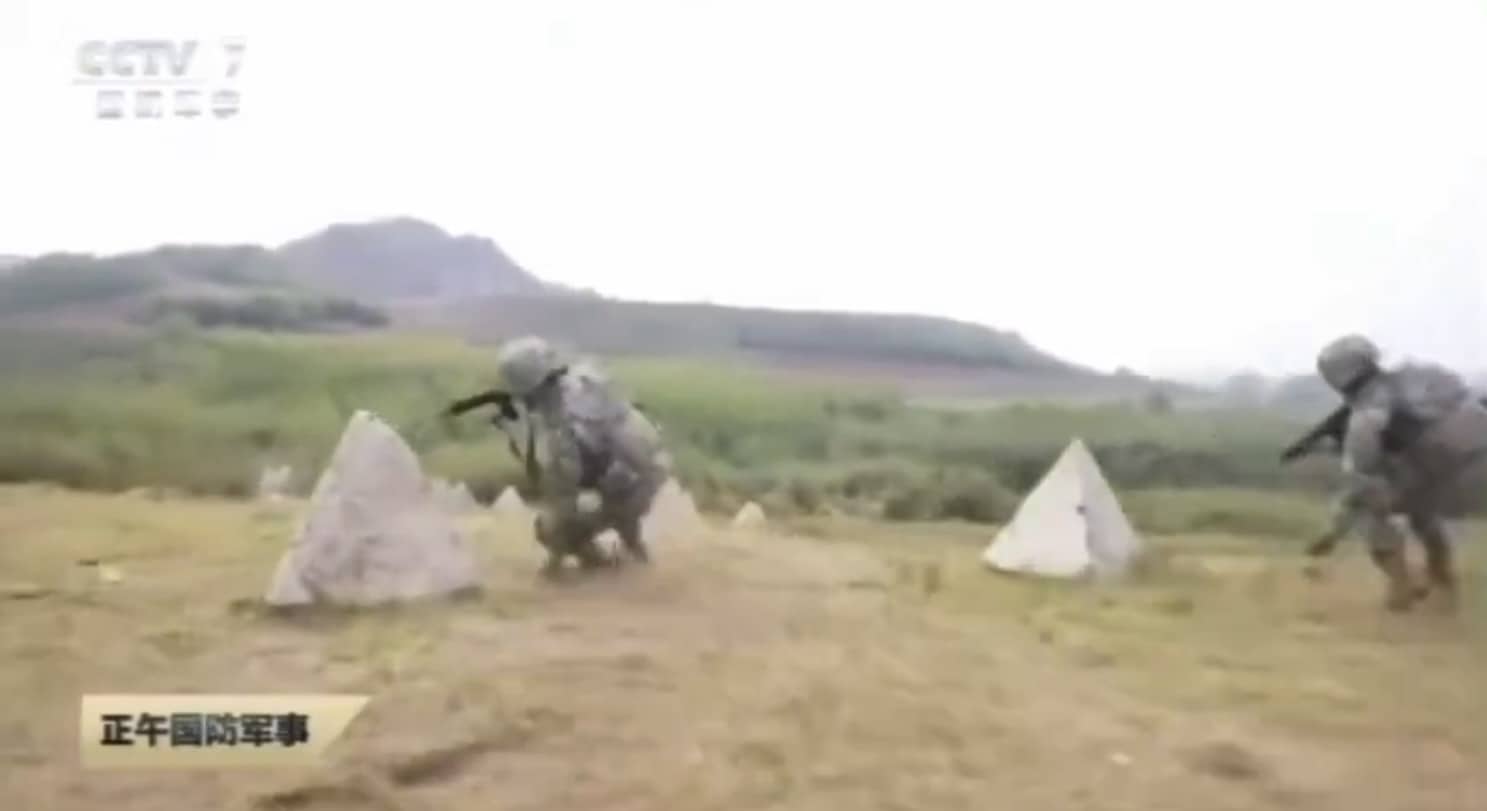 Swarm of small FPV drones flying in formation during Chinese military training.