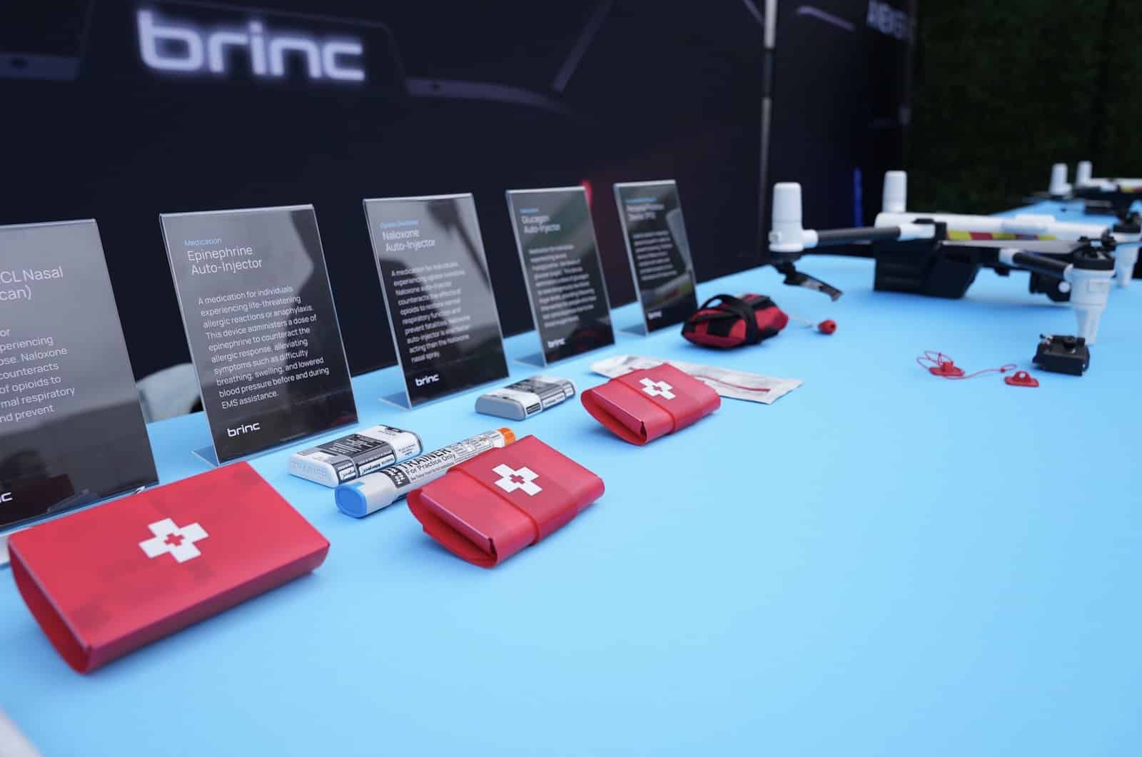 BRINC display table with red medical kits and a Responder drone on show.