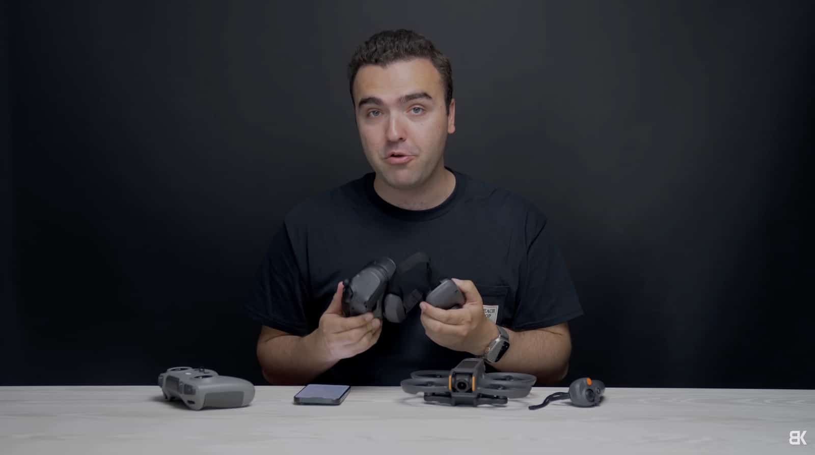 Billy Kyle holding the Goggles 3 at a desk with drone and controller laid out.