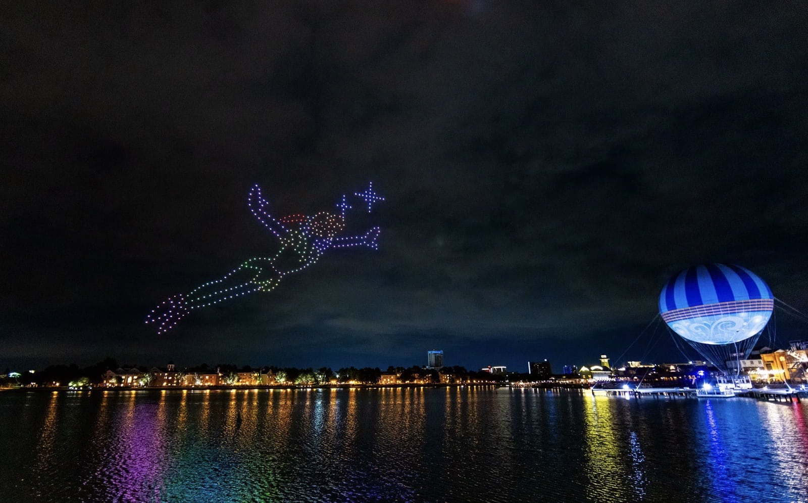 Tinker Bell drawn in drone lights above the water at Disney Springs.