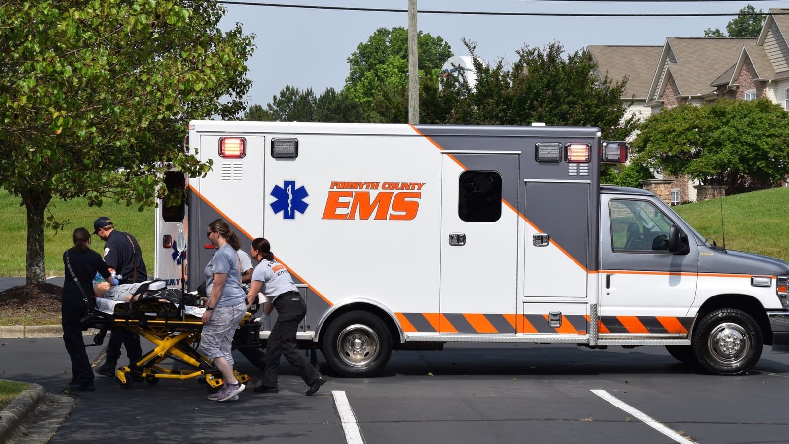 Forsyth County EMS crew wheeling a stretcher to their ambulance during the drill.