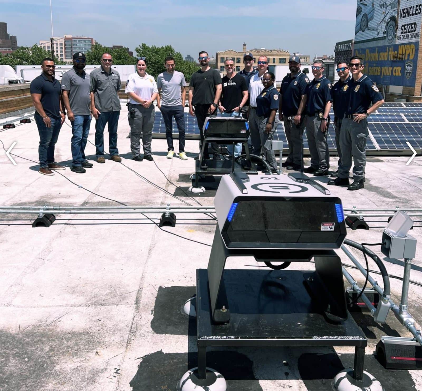 NYPD officers and Skydio staff gather around a rooftop drone dock.