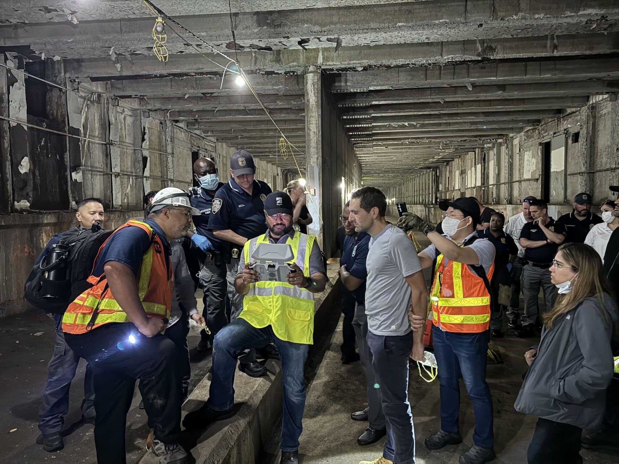 Officers and transit workers gather in a subway tunnel during a Nightsense demo.