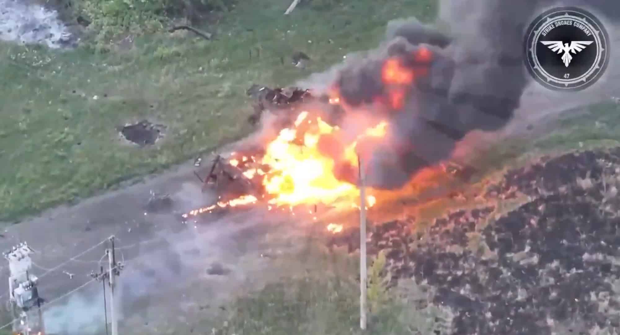 Fireball and black smoke rising from the same spot after the tank detonates.