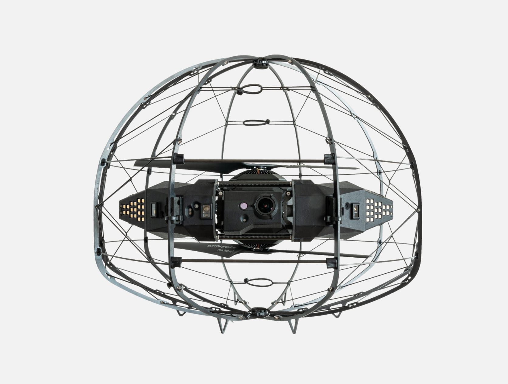 Caged inspection drone with camera and lights inside its spherical protective frame.