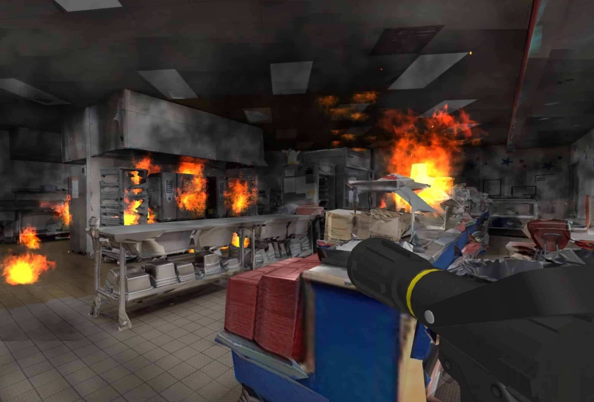 First-person simulation of a kitchen fire with an extinguisher nozzle in view.