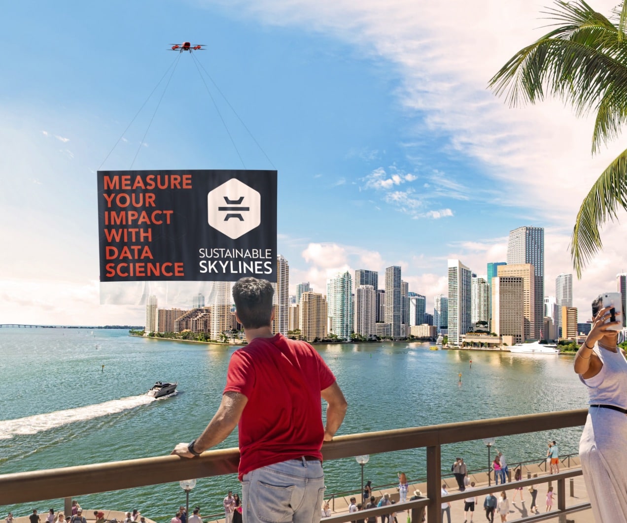 A drone tows a Sustainable Skylines banner over the Miami waterfront skyline.