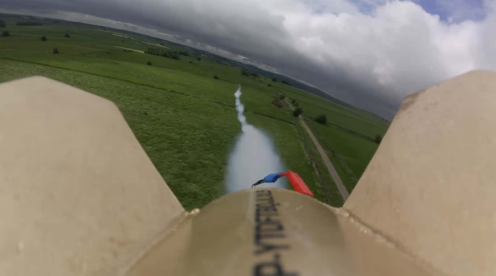 Onboard camera view from the rocket drone climbing above a green farm field.