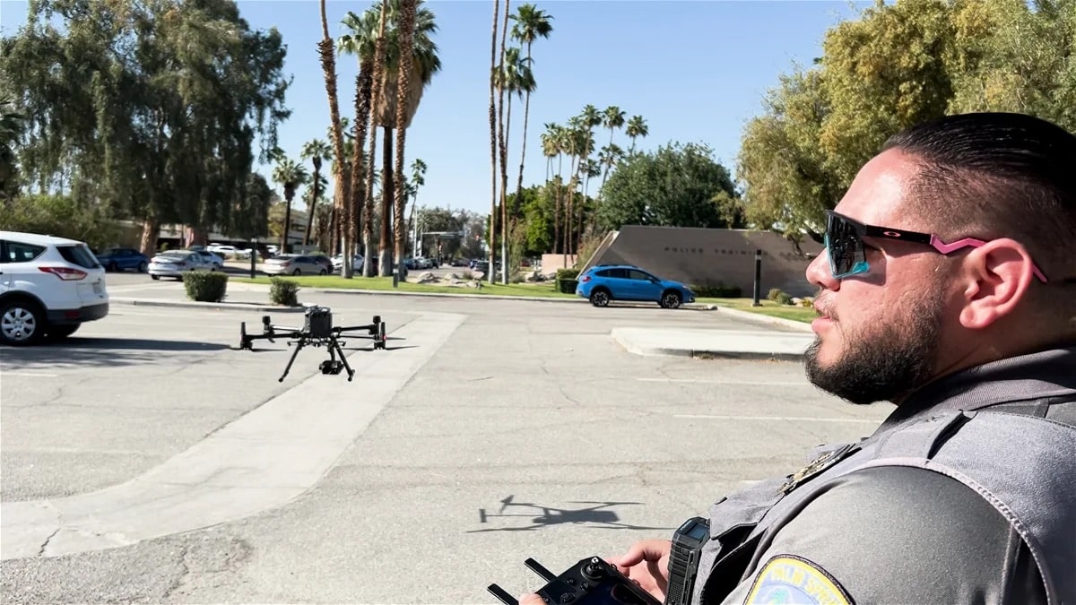 Palm Springs officer flying the Matrice over a lot lined with palm trees.