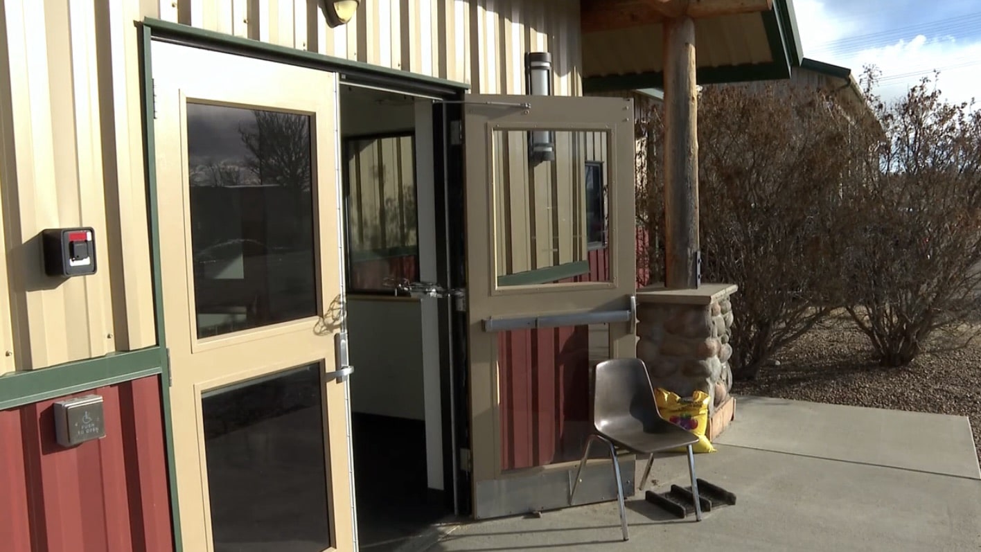 Propped-open glass doors of the building deputies searched with an indoor drone.