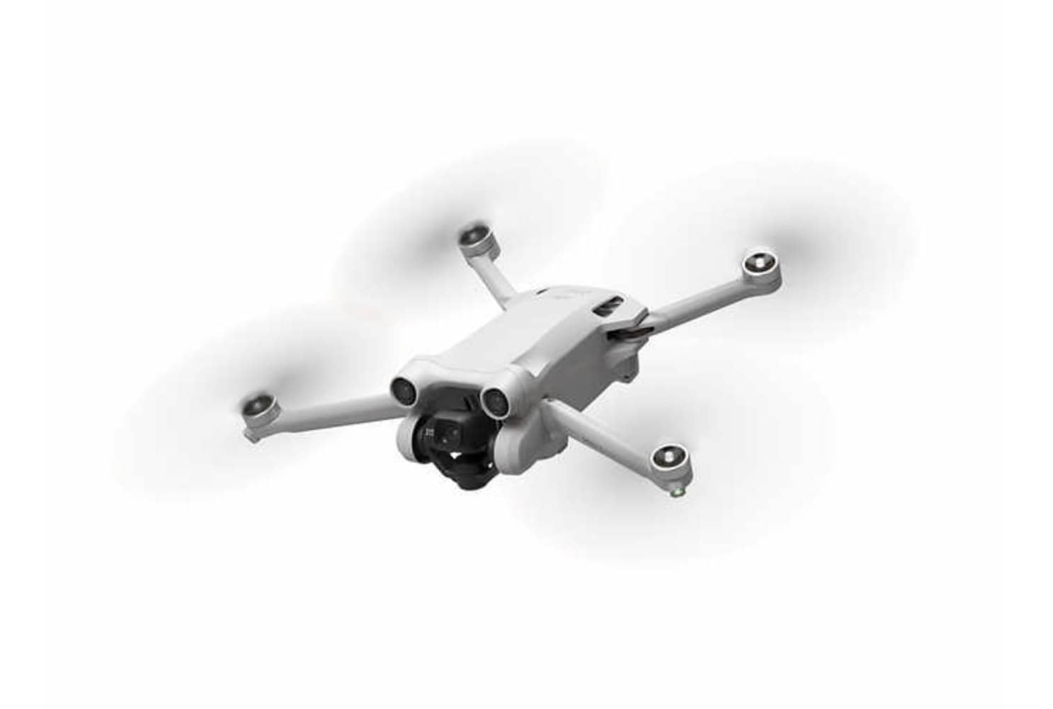 The DJI Mini 3 Pro in flight with its propellers blurred.