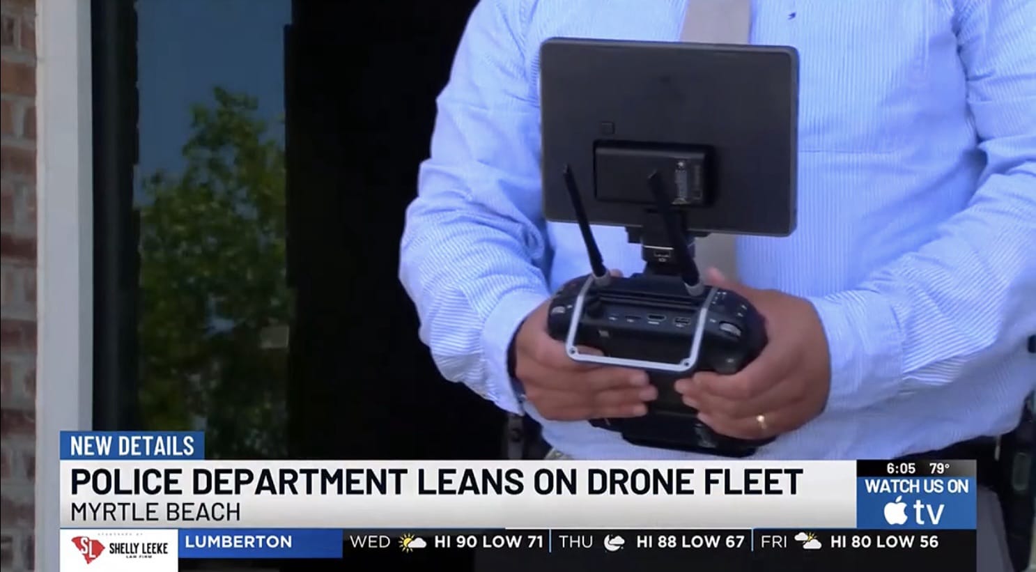 A Myrtle Beach officer holds a drone controller with a tablet mounted above.
