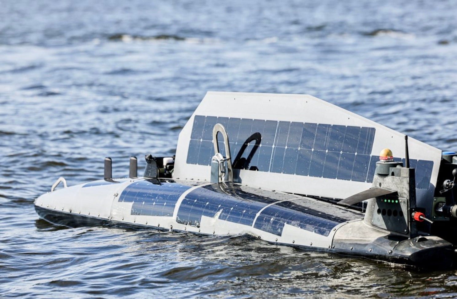 Close-up of the TRITON unmanned vessel with its solar panel sails deployed.
