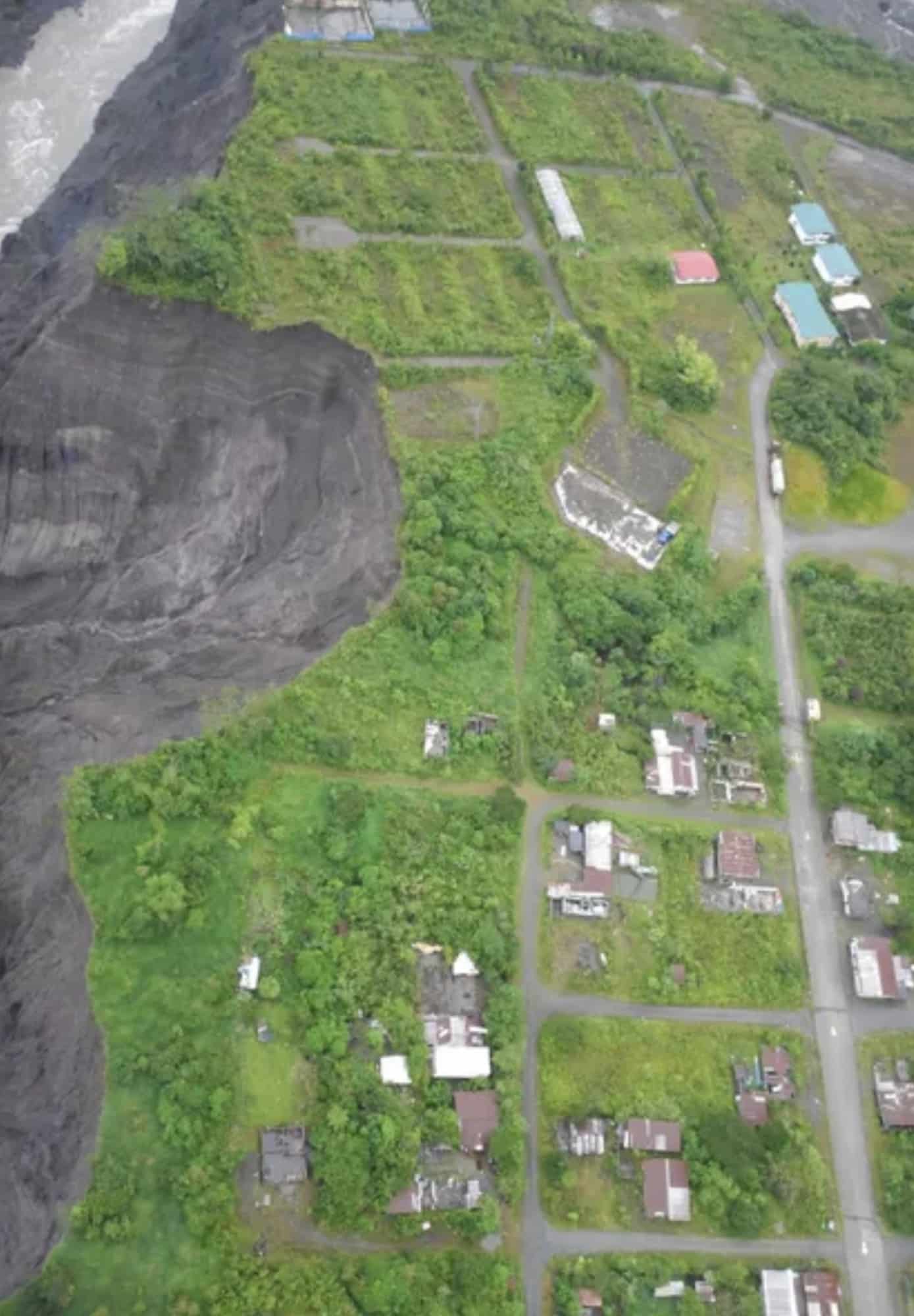 Aerial view of a grey erosion scarp cutting into farmland beside El Chaco.