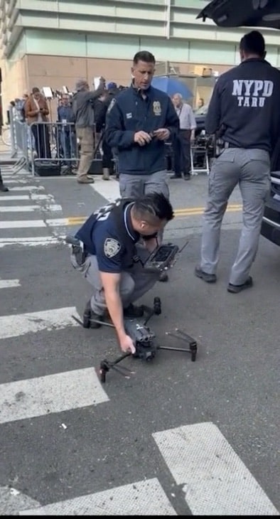 NYPD Technical Assistance officers preparing a quadcopter on a barricaded Manhattan street.