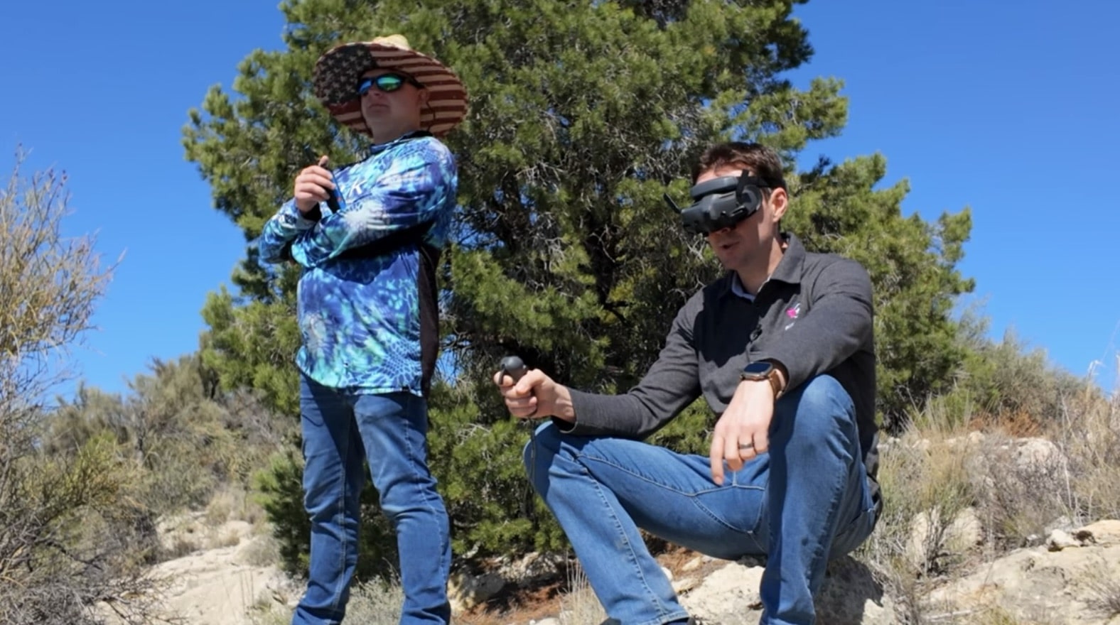 Two Pilot Institute testers in the high desert, one wearing DJI Goggles 3.