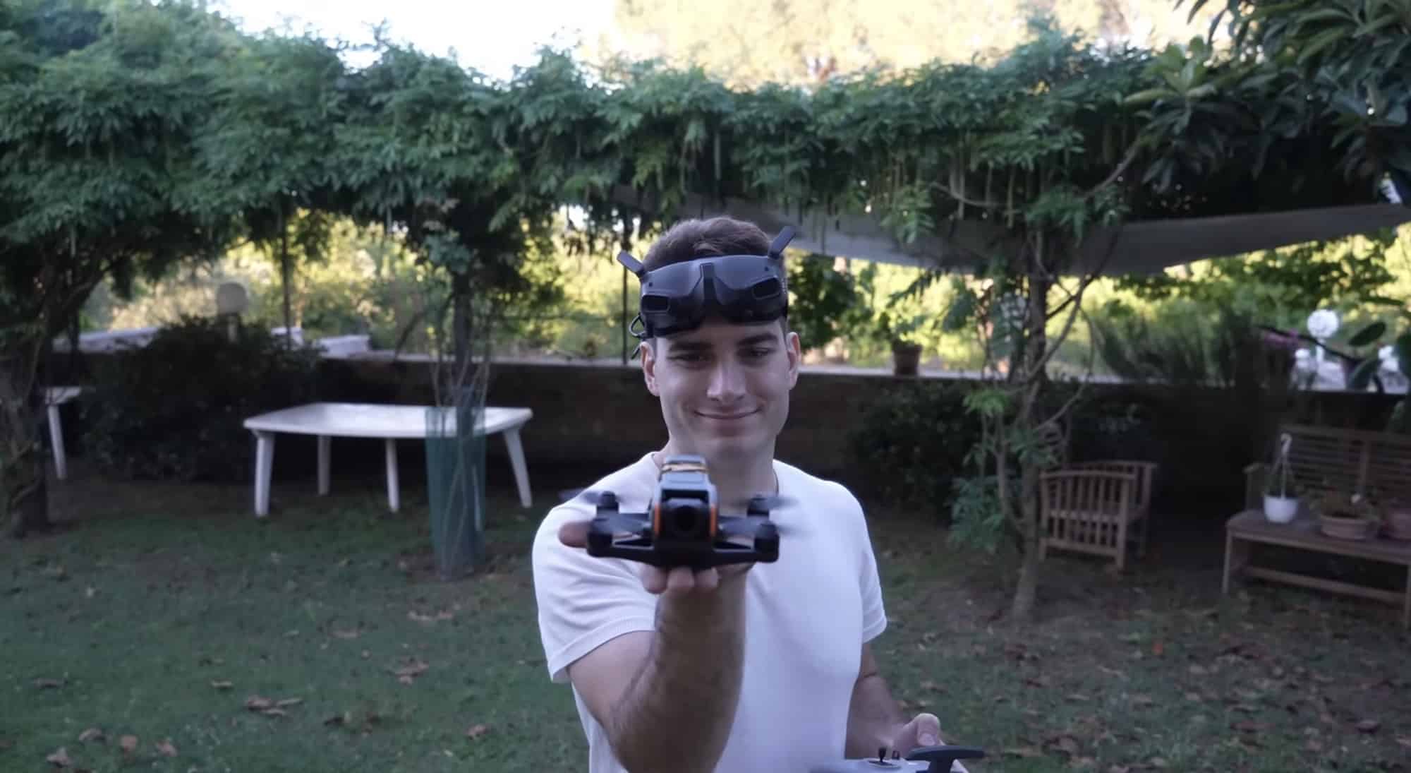 Rimzler holding the cut-down DJI Avata 2 toward the camera in a garden.